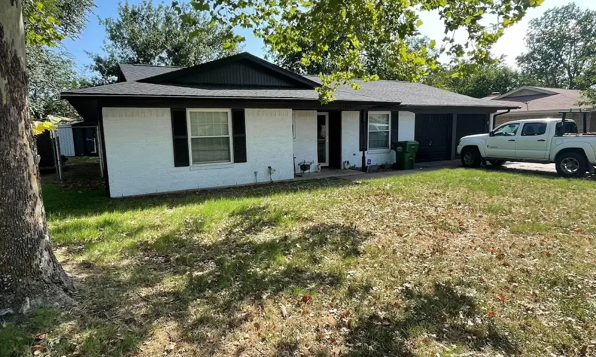 Professional roofing crew working on a residential roof in Dover